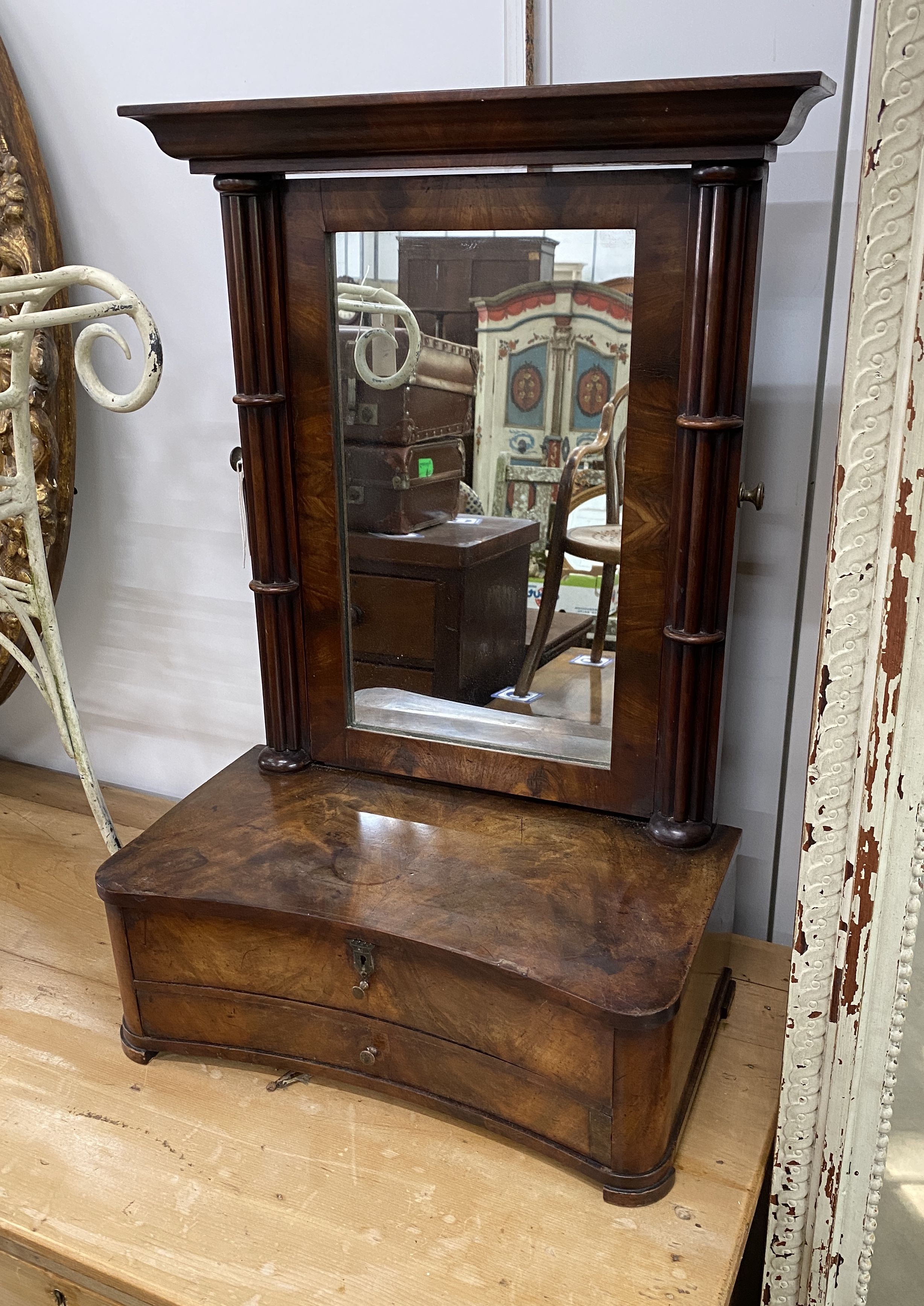 A 19th century Continental mahogany toilet mirror, with concave two drawer base, width 48cm, depth 26cm, height 72cm